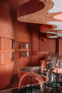 Modern interior design featuring glass and terracotta elements.