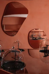 Modern retail store with glass display cases showcasing small sculptures and antiques.
