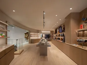 A modern retail space featuring wooden shelves and displays.