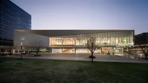 A modern shopping center with a glass and concrete exterior.