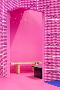 An interior design space featuring minimalist aesthetics with a pink color scheme.