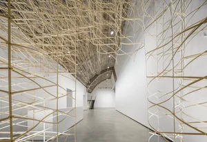 An interior space featuring minimalist design elements made of metal and glass materials.