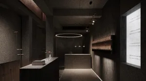 A minimalist retail storefront featuring concrete walls and a large window.