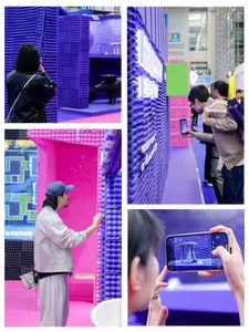People exploring a colorful exhibition space decorated with foam blocks.
