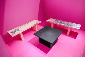 Modern furniture featuring geometric patterns and vibrant colors in a pink room.