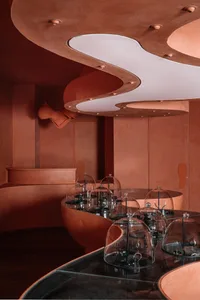 Modern retail space featuring glass domes on display tables.