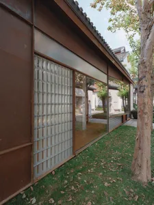Modern retail storefront with glass block windows and concrete roofing