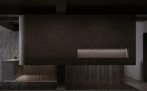 A modern lobby interior with a concrete wall and floor, featuring a minimalist design.