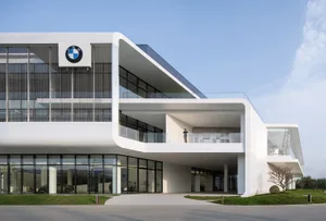 Modern, minimalist commercial building with glass and concrete materials.