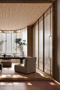 A minimalist living room featuring wooden elements, with a sleek black table and comfortable seating.