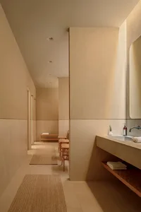 A modern bathroom with sleek concrete walls, minimalist design, and natural textures.