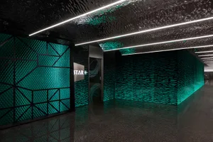 Modern corporate lobby featuring glass paneling walls and ceiling