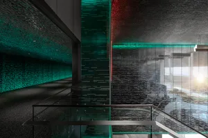 A modern office corridor with glass walls and red and green lighting.