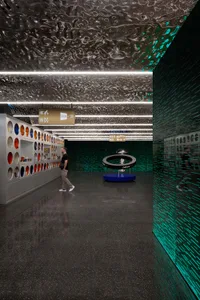 A modern office space featuring glass walls and a futuristic design.