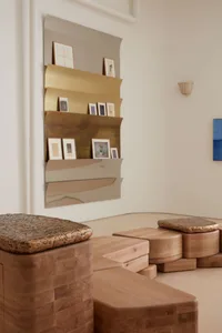 Modern art installation featuring abstract sculpture on wooden and metallic platforms.