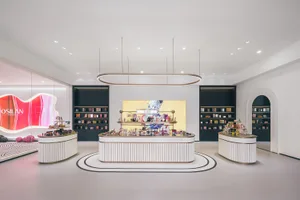 Modern interior design of a cosmetics retail store with sleek, clean lines and contemporary fixtures.