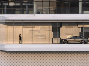 Modern architectural design featuring glass walls and interior elements.