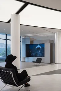 A modern office lobby featuring sleek concrete and glass design elements.