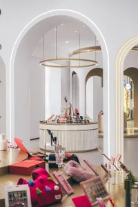 A modern retail store with a circular counter and colorful products on display.
