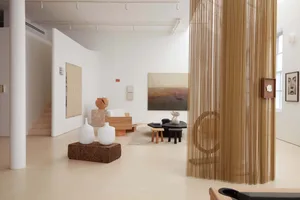 Interiors of a modern art gallery showcasing mixed-media art installations and sculptures.