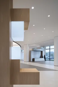 A modern lobby features wooden paneling.