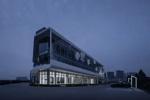 A modern office building with glass walls and concrete accents.