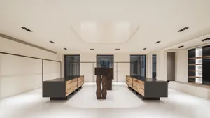Minimalist showroom featuring natural wood cabinets and polished concrete floor