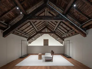 Minimalist room featuring wood, concrete and glass materials.