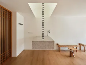Modern minimalist living room featuring a stone floating platform and minimalist furniture.