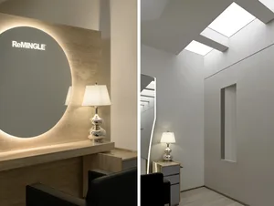 Modern office space with minimalist design, featuring exposed concrete walls and a sleek, contemporary aesthetic.
