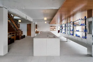 A minimalist office space featuring concrete and glass materials.