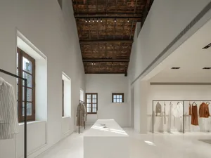 Modern retail store with minimalist design and white painted walls and ceiling.