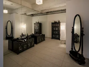 A retail storefront with wooden cabinets and mirrors.