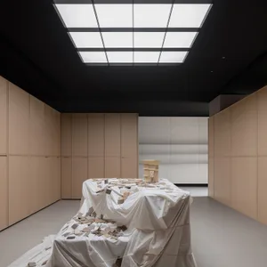 A minimalist art installation featuring fabric, wood, and mixed media materials.