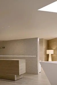 Minimalist interior design with concrete walls and floor, featuring clean lines and a modern aesthetic.