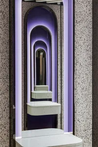 A modern bathroom interior with a glass partition and transparent border design.