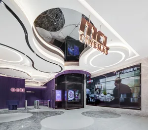 Modern cinema entrance featuring concrete and marble design elements.