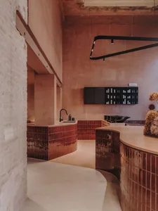 Modern hair salon with terracotta tiles, concrete accents, and minimalist design