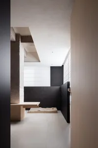 Modern interior design featuring concrete, wood, and stone elements.