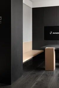 Modern office space with black interior and minimalist design, featuring sleek steel and glass elements.
