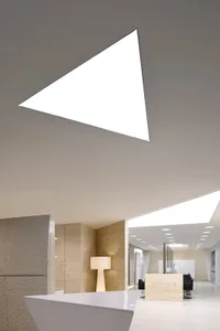 Modern office space with a large transparent window and minimalist design.