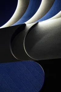A section of modern architecture with metal textures and sleek, curved lines.