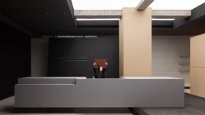 A modern lobby interior with concrete walls and minimalist design features.