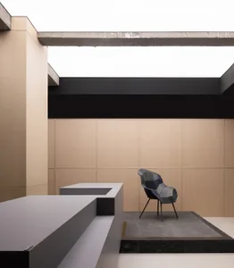A modern minimalist lounge featuring metallic textile furniture, minimalist design, and a sleek, contemporary look.