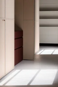 A minimalist closet interior with light wooden cabinets and drawers.