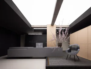 A modern office space with a white concrete floor, minimalist furniture, and a sleek desk.