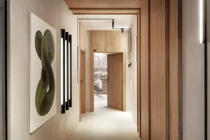 A minimalist office interior with wooden walls and white surfaces.