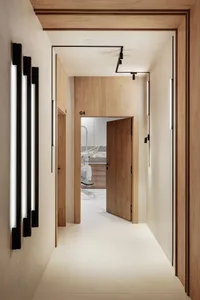 A minimalist office with wooden and concrete materials.