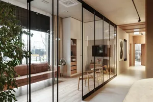 Modern living room with wooden furniture and glass walls.