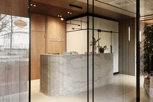 A modern minimalist office lobby with a stone counter.